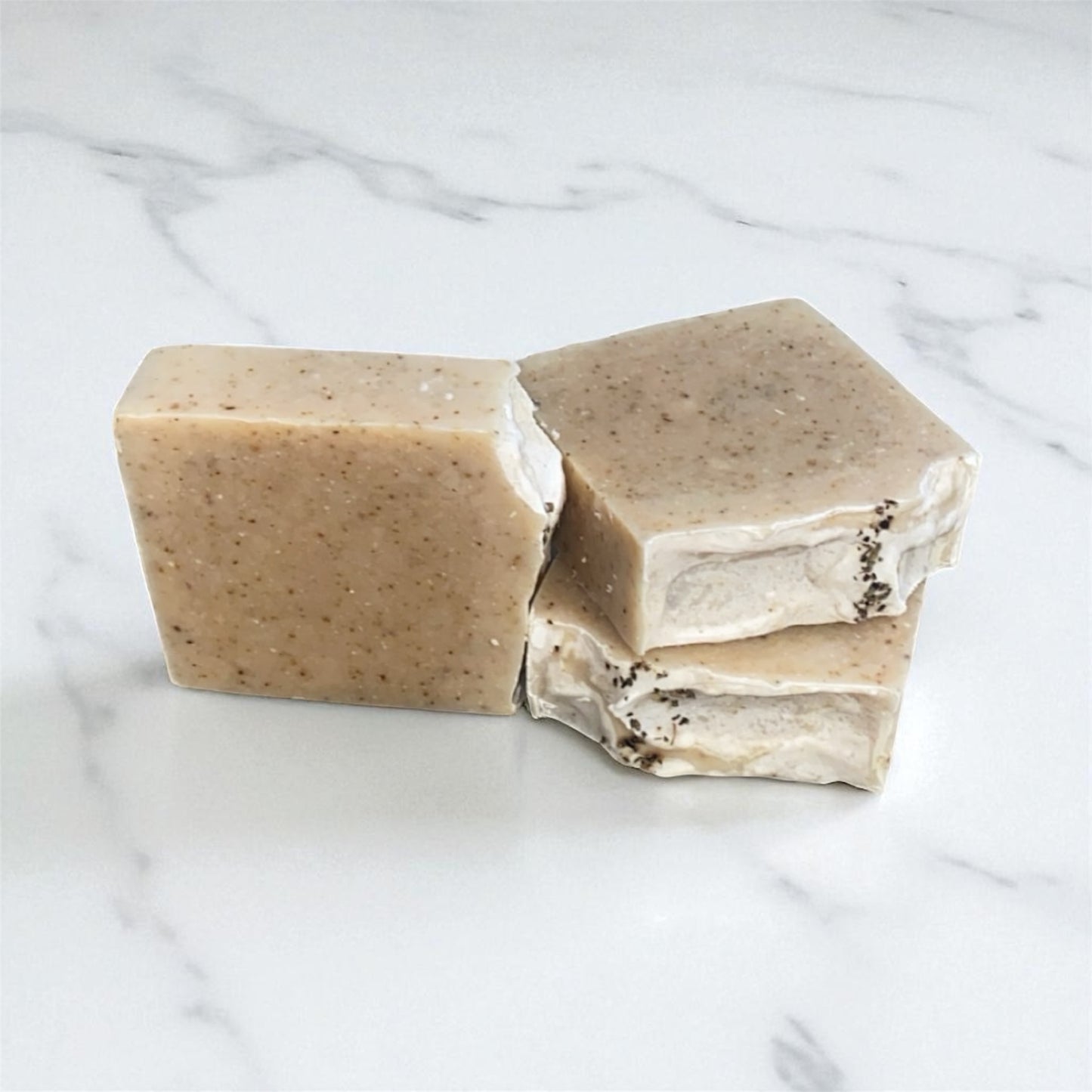 Three bars of soap on a marble surface
