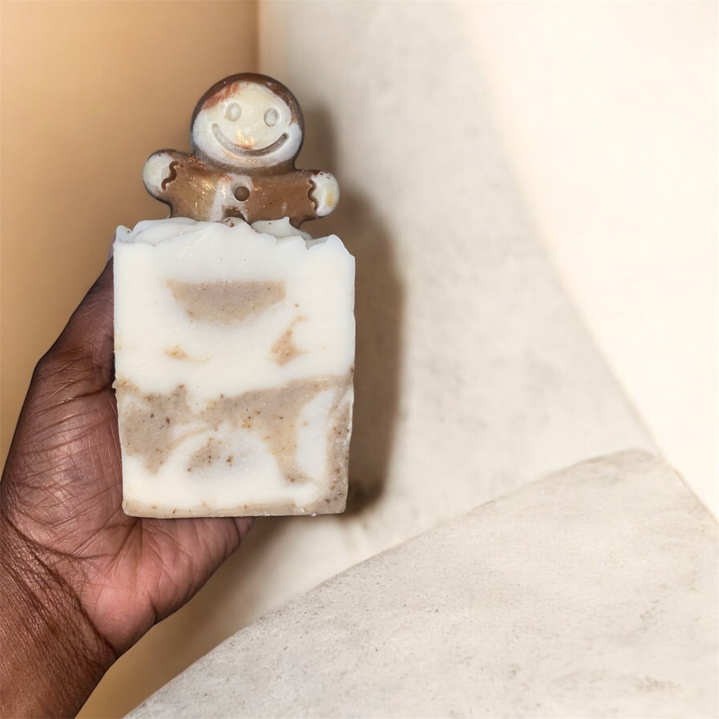 1 small soap with a gingerbread man figures on top with marbled design on a beige background