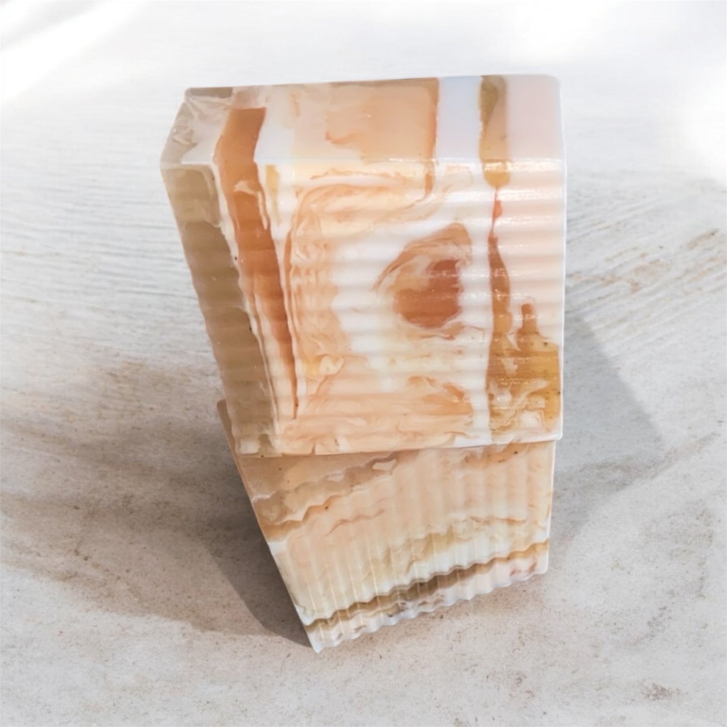 Decorative stone block with 2 soaps on a light surface