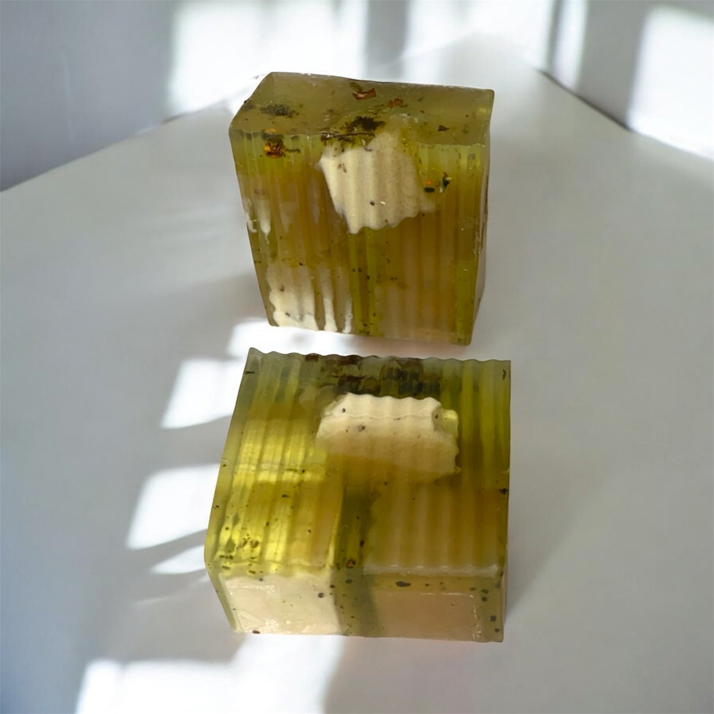 Two soap blocks with a textured surface on a white background