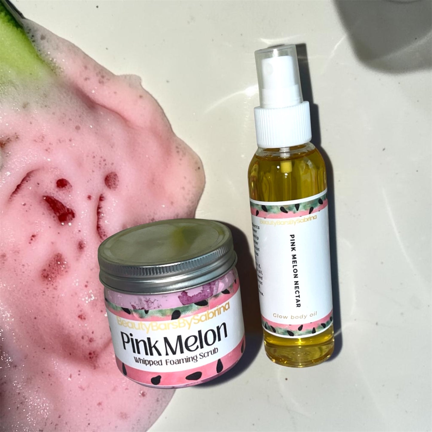 Pink Melon skincare products including a jar and bottle on a textured surface.