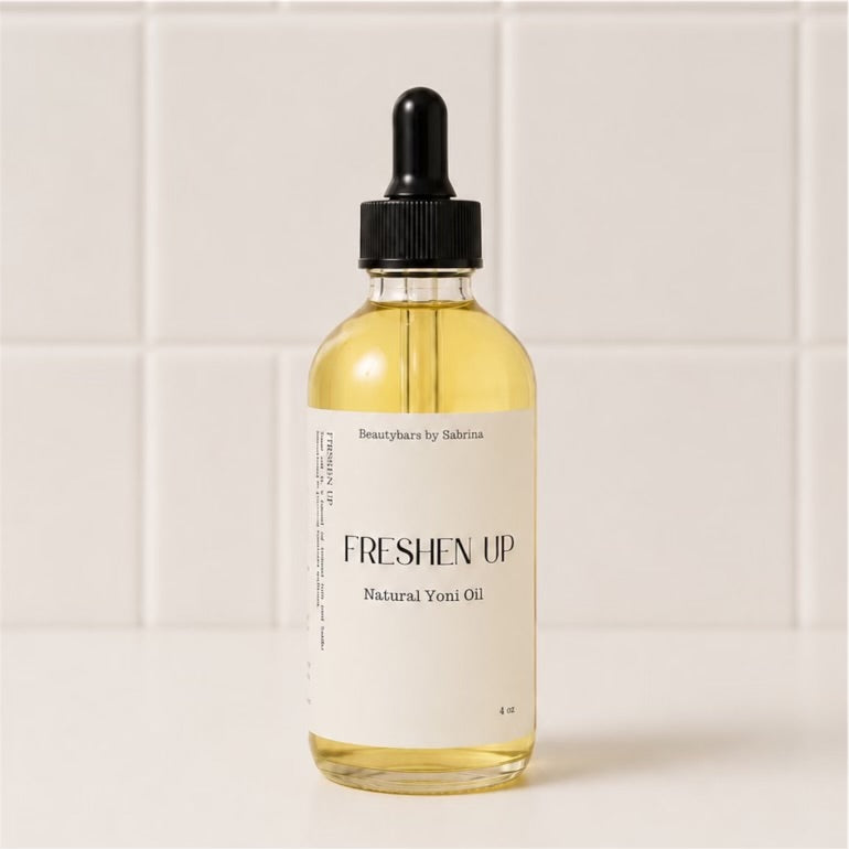 Bottle of 'Freshen Up' natural yoni oil with a dropper on a white background