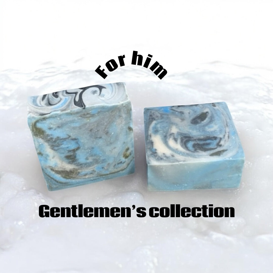 2 blue marbles color soaps around suds displaying gentlemen collection for him