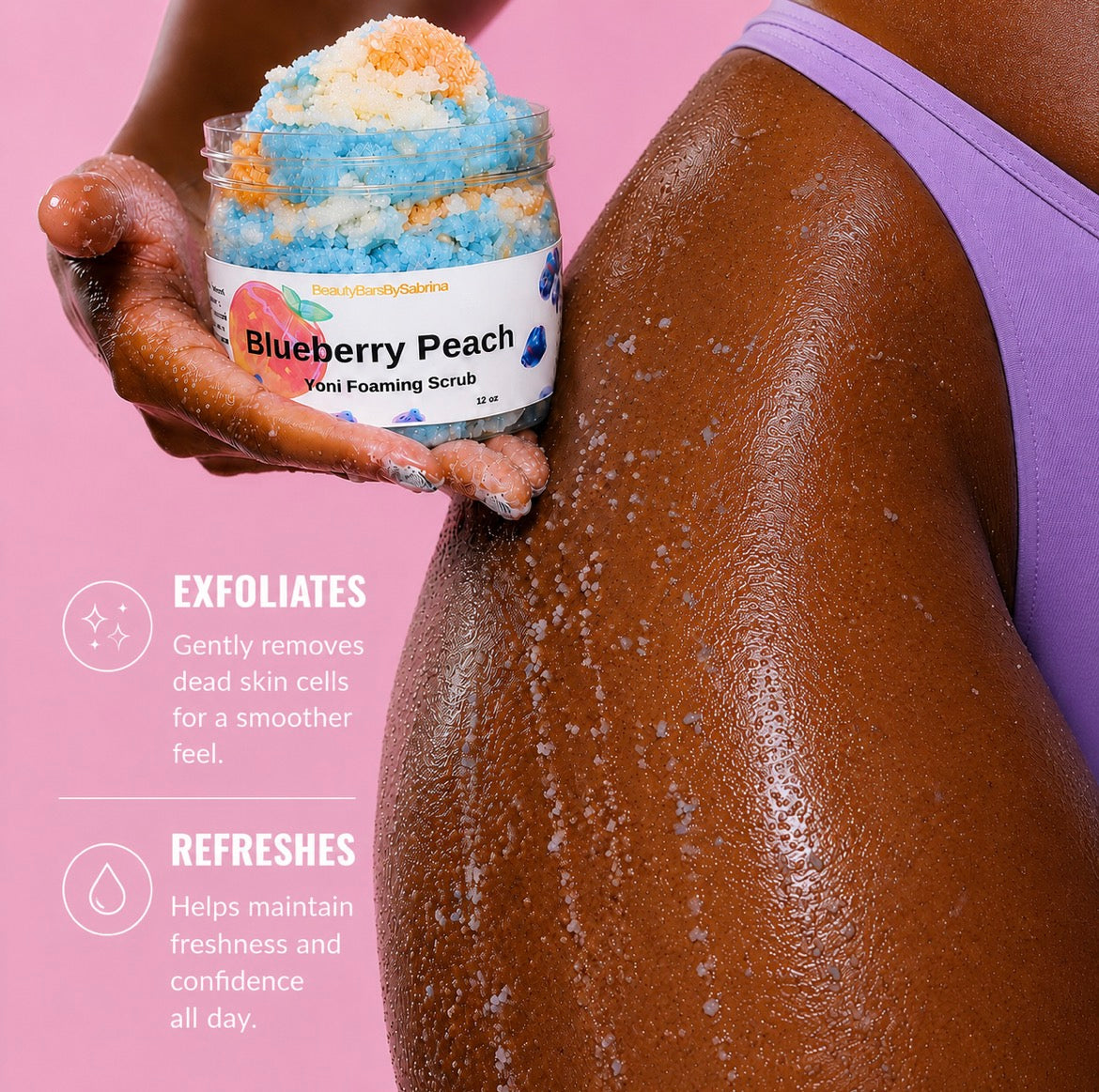 A person applies blueberry peach exfoliating scrub from Yoni Foaming Scrub onto their back. The person is wearing a purple sports bra, and the background is a solid pink color with text describing the benefits of the exfoliating scrub.