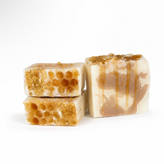 Three pieces of honeycomb soap on a white background