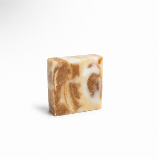 Bar of soap with brown and white swirls on a white background