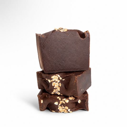 Stack of three chocolate bars with oat meal flakes on a white background