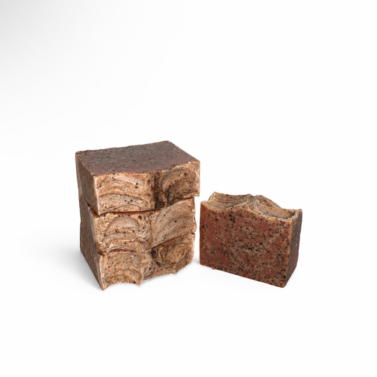 Three brown soap bars with a marbled pattern on a white background