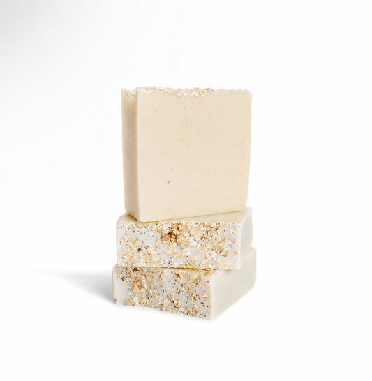 Two stacked soap bars with gold and silver glitter on a white background