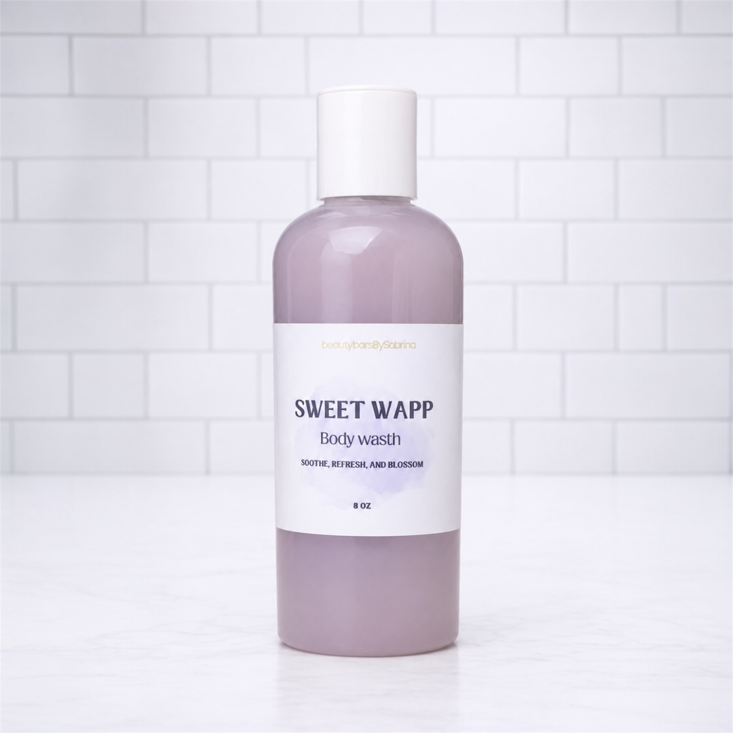 Bottle of Sweet Wapp body wash on a white tiled background