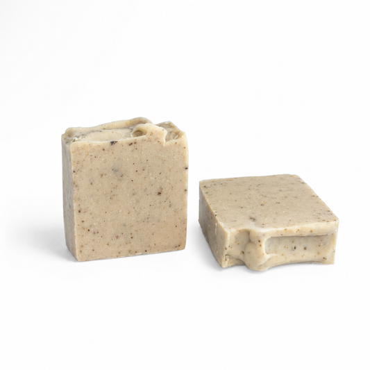 Two rectangular bars of handmade soap with a speckled beige texture, shown on a plain white background.