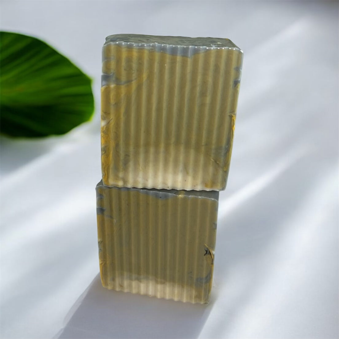 2 soaps stacked on top of each others with white background 