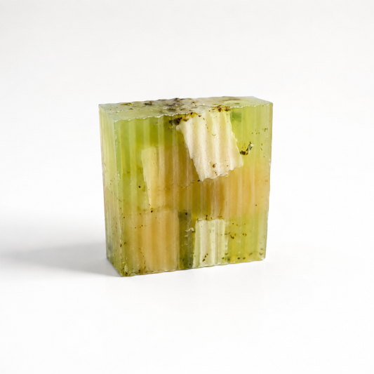 Green and white striped soap bar on a white background