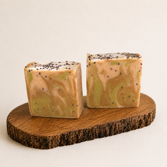 Two square-shaped soaps with a marbled pattern on a wooden stand against a light background