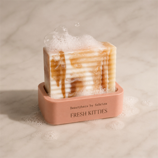 Bar of soap with a pink holder labeled 'Fresh Kitties' on a neutral background