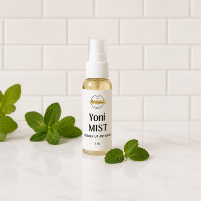 Bottle of Yoni Mist with mint leaves on a white tiled background