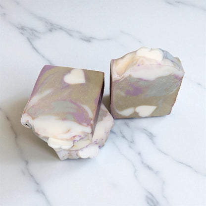 Two marbled soap bars on a marble surface 
