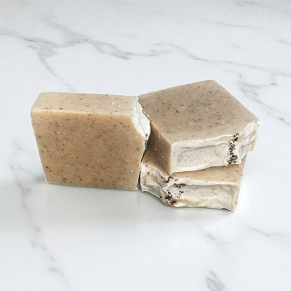 Three bars of soap on a marble surface