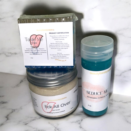 Three containers labeled 'Taste Me', 'Lick All Over', and 'Seduce Me' on a marble surface. One is a bar of soap, body scrub that foams and feminine wash made for woman.