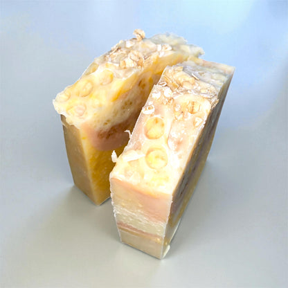 Two bars of soap with a textured surface on a light blue background