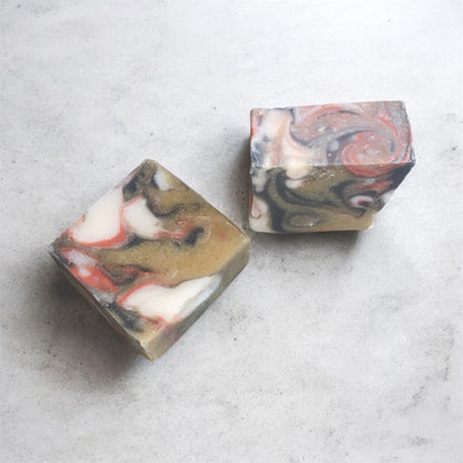 Two marbled soap bars on a light gray surface