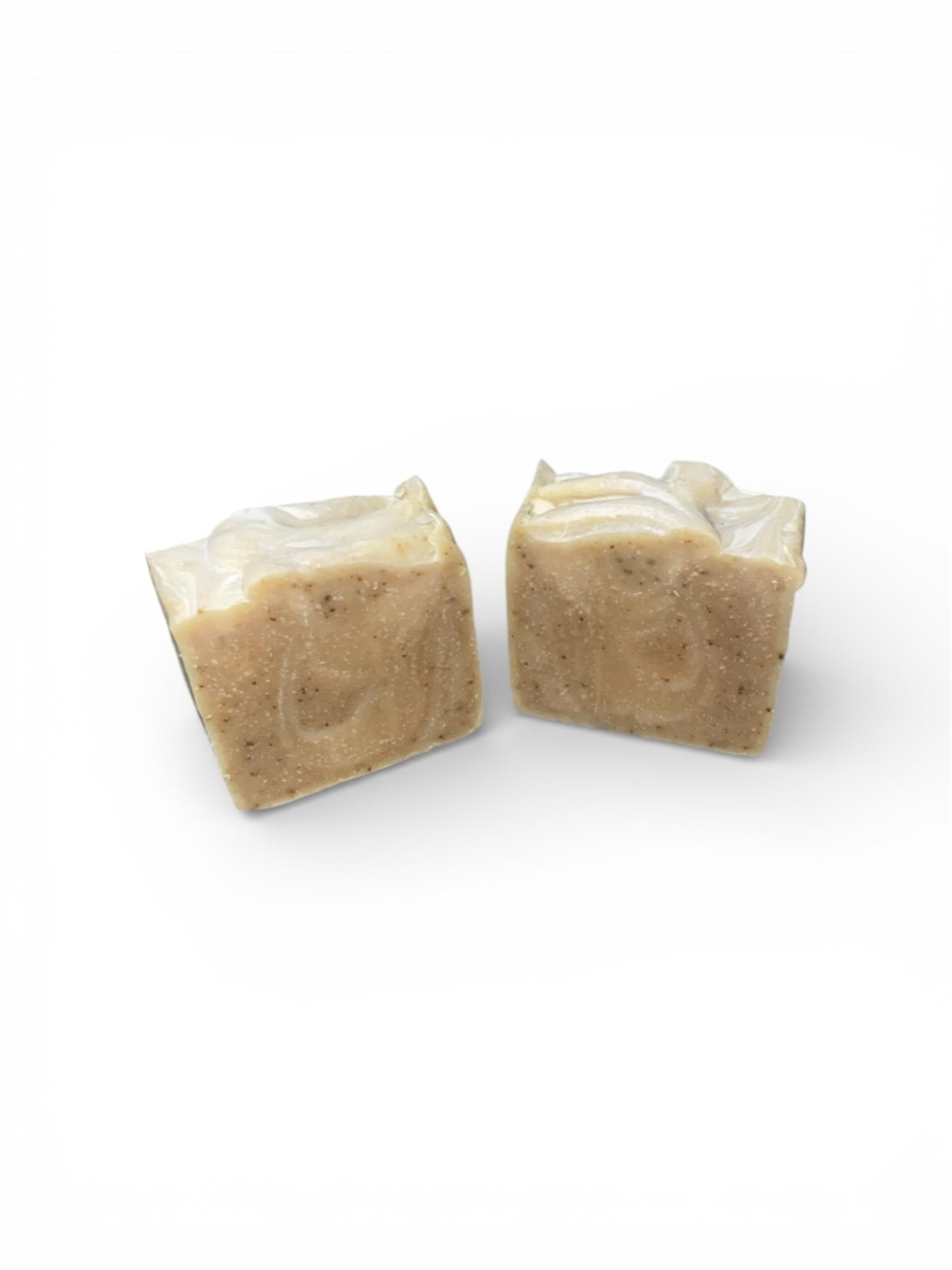 Two square bars of soap with swirls  on a white background