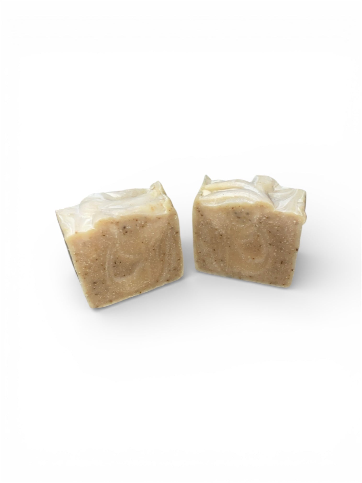 Two square bars of soap with swirls  on a white background