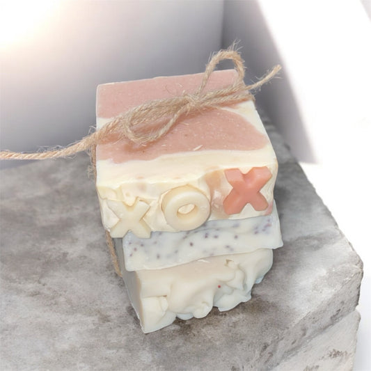 Stack of soap bars with decorative designs on a marble surface