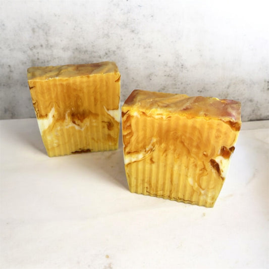 Two marbles colored turmeric soaps with white background 