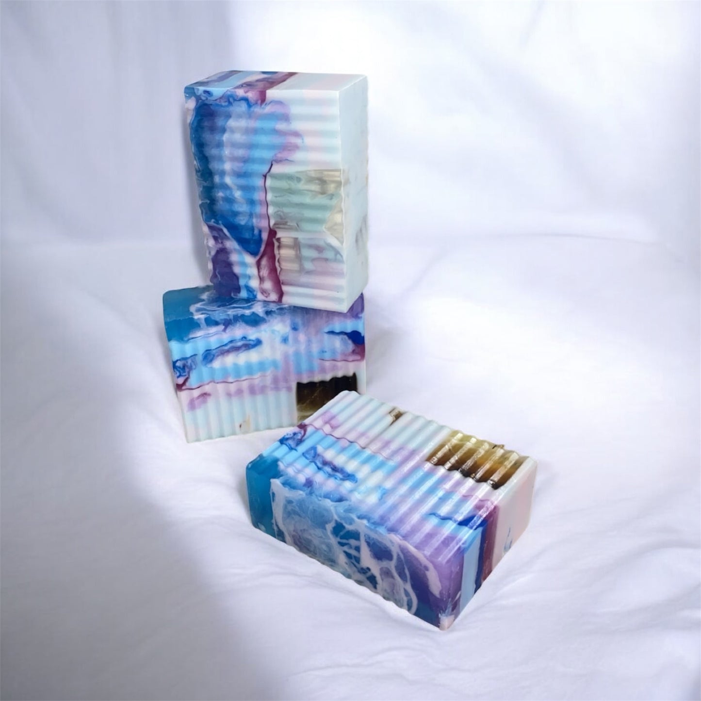 Colorful soap bars with a marbled pattern on a white background