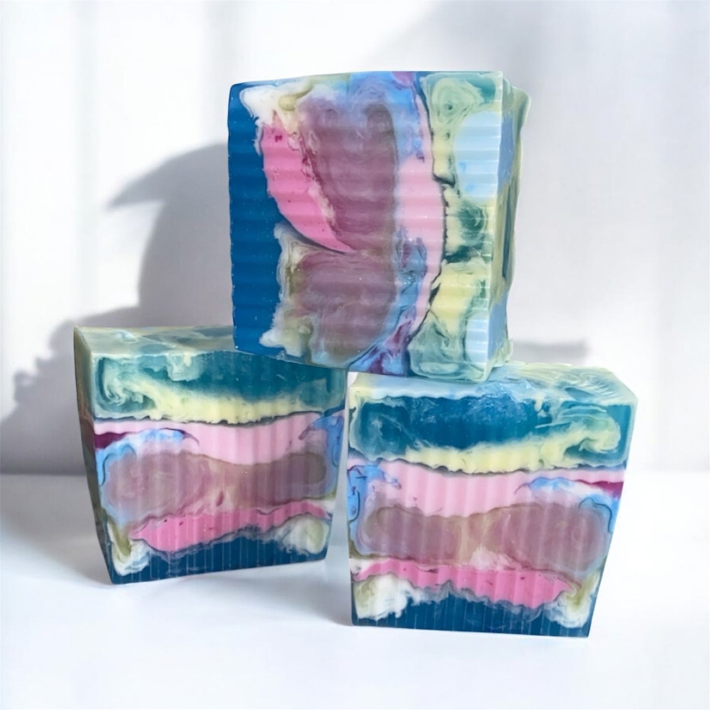 Colorful soap bars with a marbled pattern on a white background