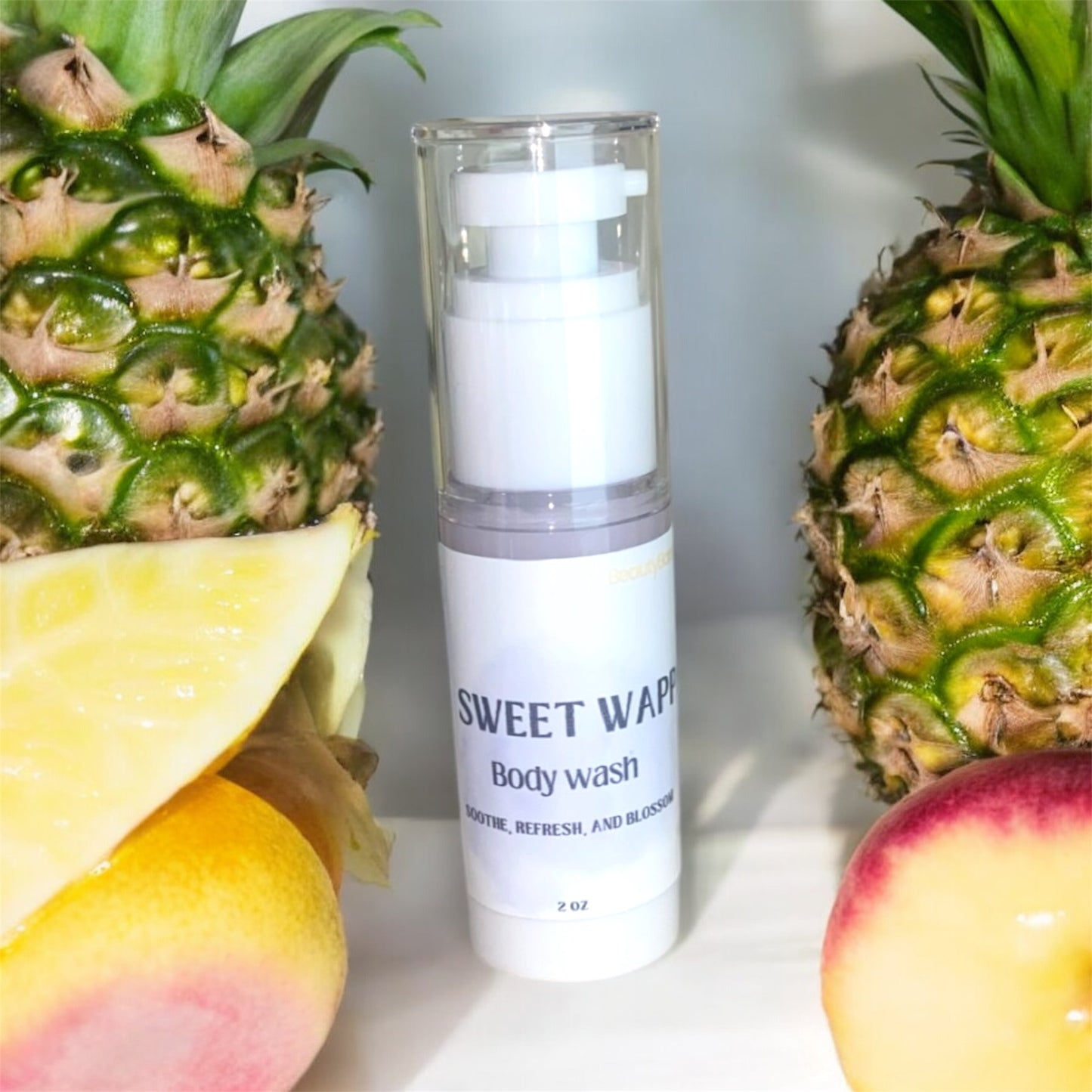 Body wash bottle labeled 'Sweet Wipe' with a pineapple and apple on a white background
