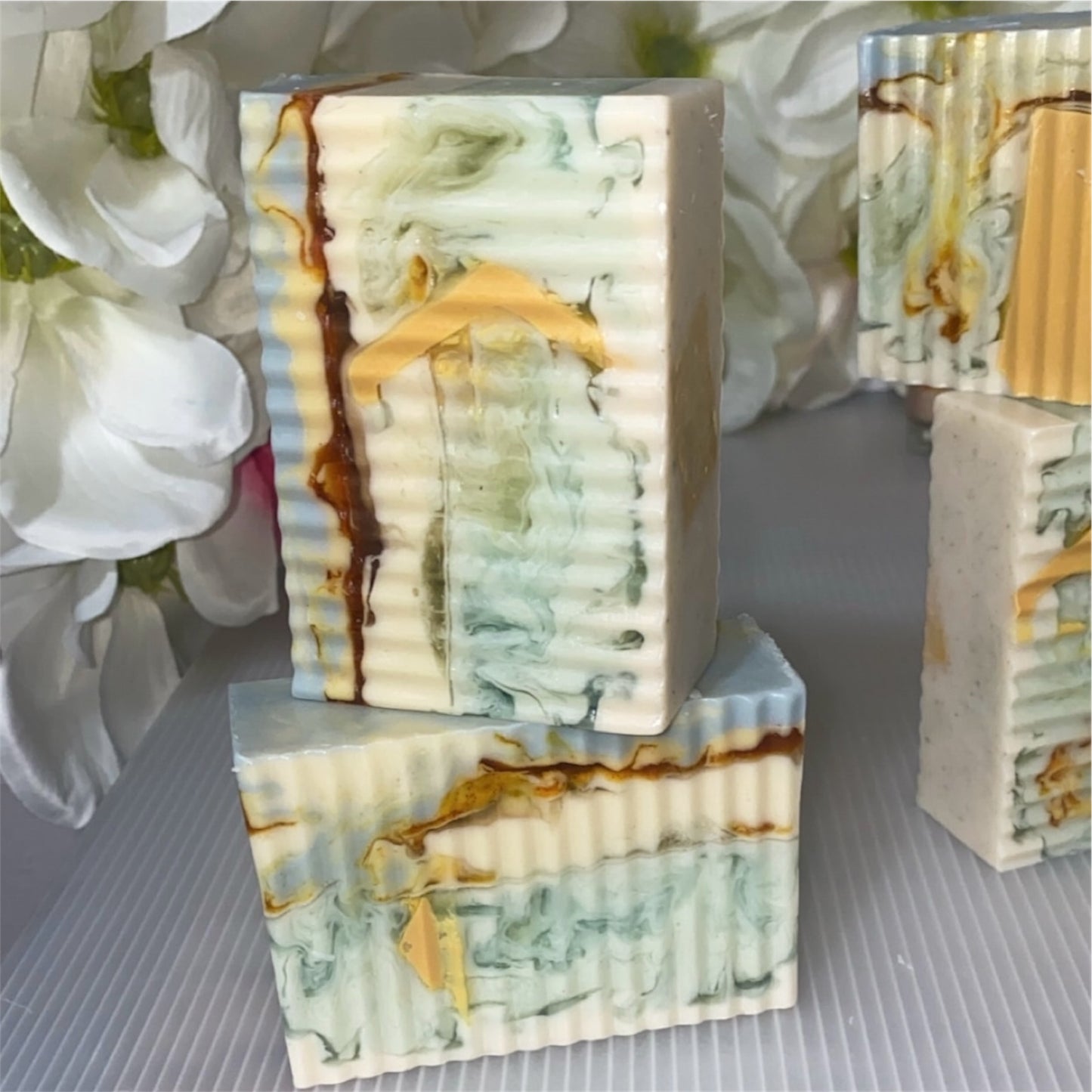 Marble-patterned soap bars with a floral background