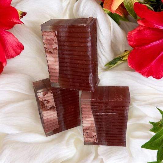 Three stacked brown rectangular bars on a white fabric background with red flowers and green leaves.