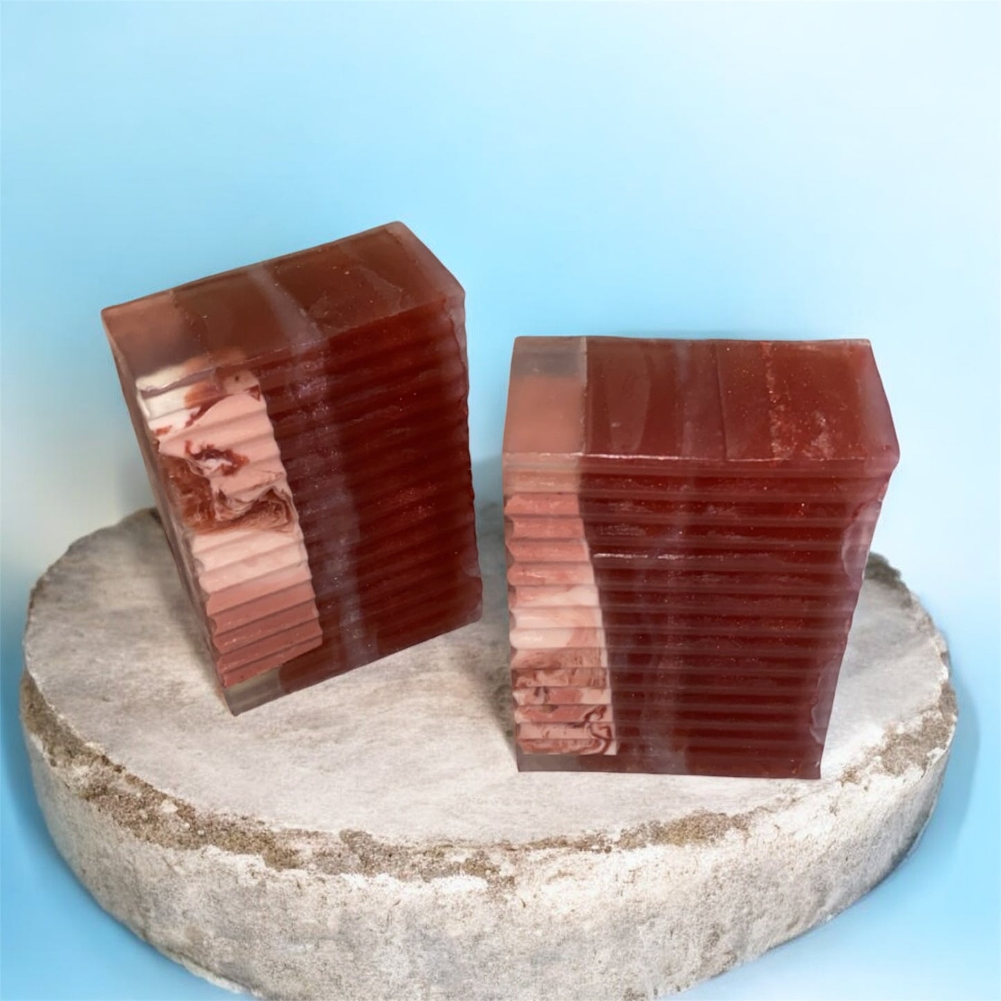 Two red stone blocks on a round stone platform with a blue background