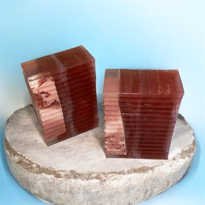 Two red stone blocks on a round stone platform with a blue background