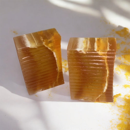 Two rectangular amber-colored soaps on a light background