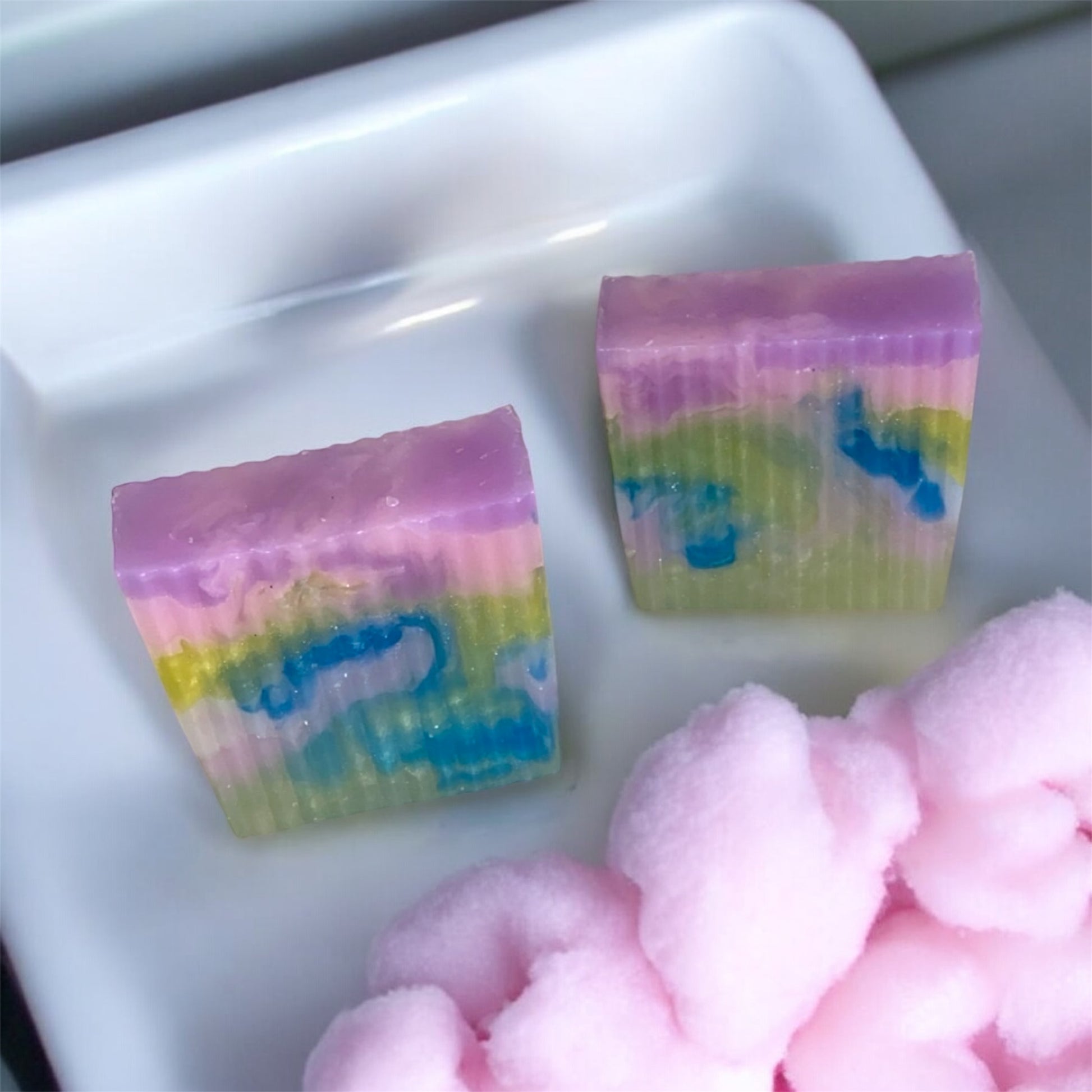 Two colorful soap bars with a white background
