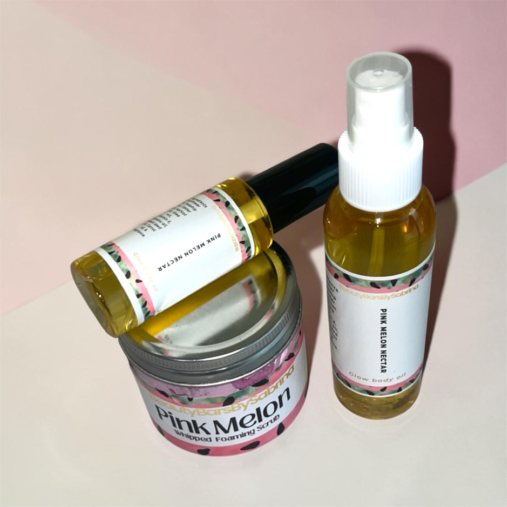 Two skincare products, a jar and a spray bottle, with 'Pink Melon' label on a light pink background.