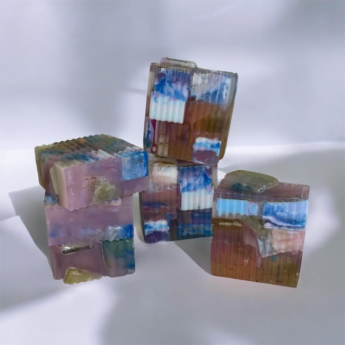 Colorful stacked soap bars on a white background
