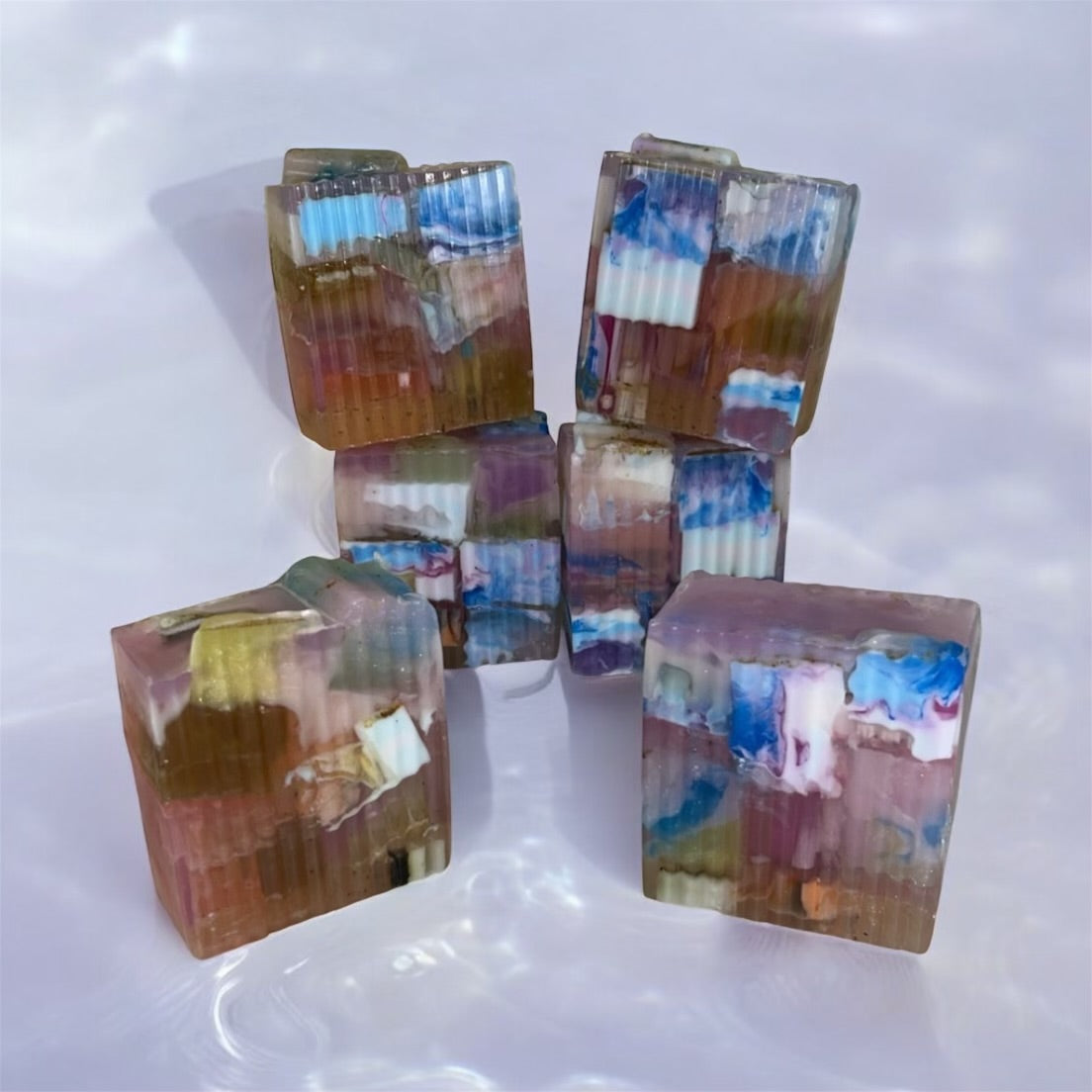 Colorful soaps blocks stacked on a white surface
