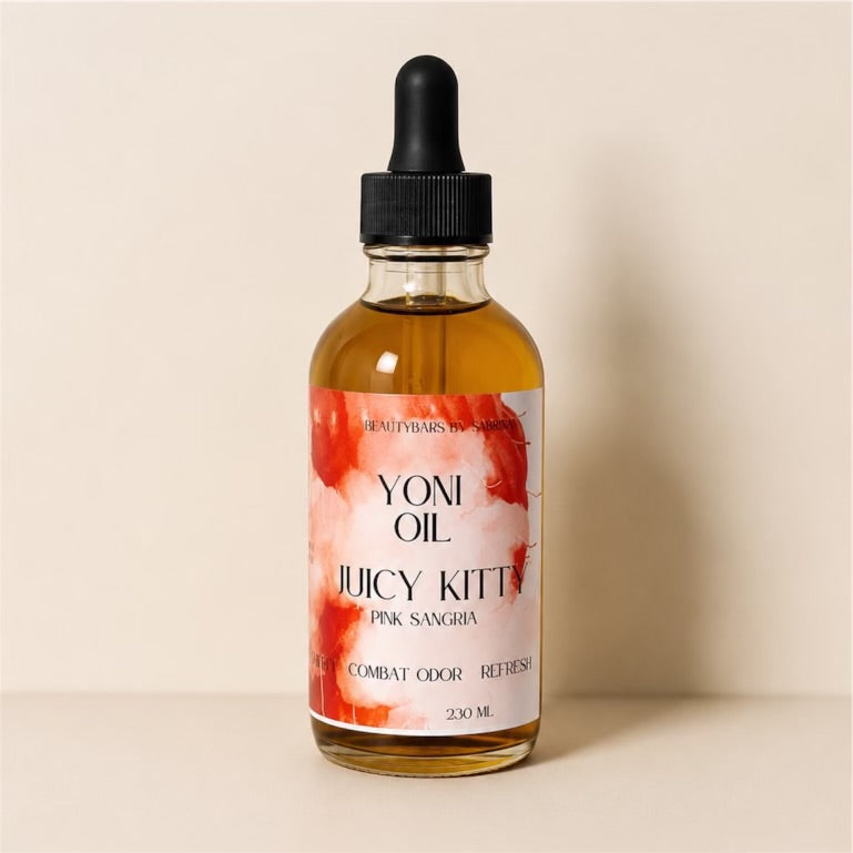 Bottle of Yoni Oil with a floral label on a beige background