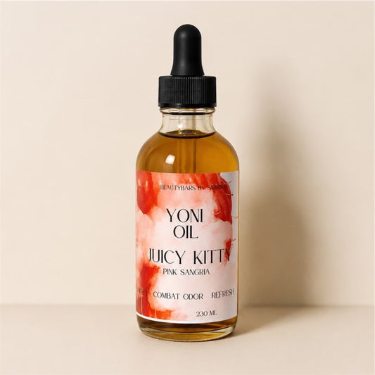 Bottle of Yoni Oil with a floral label on a beige background