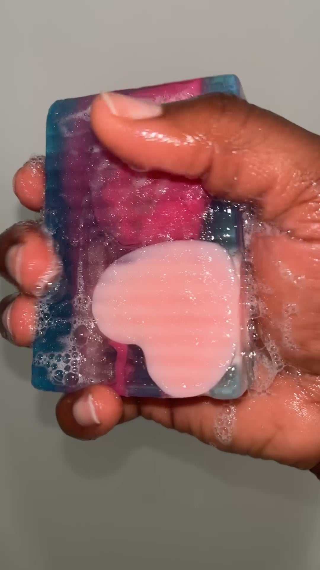 Video showing the soap lathering while being held in hand with white background 