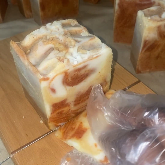 Cutting into turmeric soap with brown and white colors