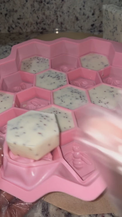 unmolding hexagon shaped soaps with cranberry seed.